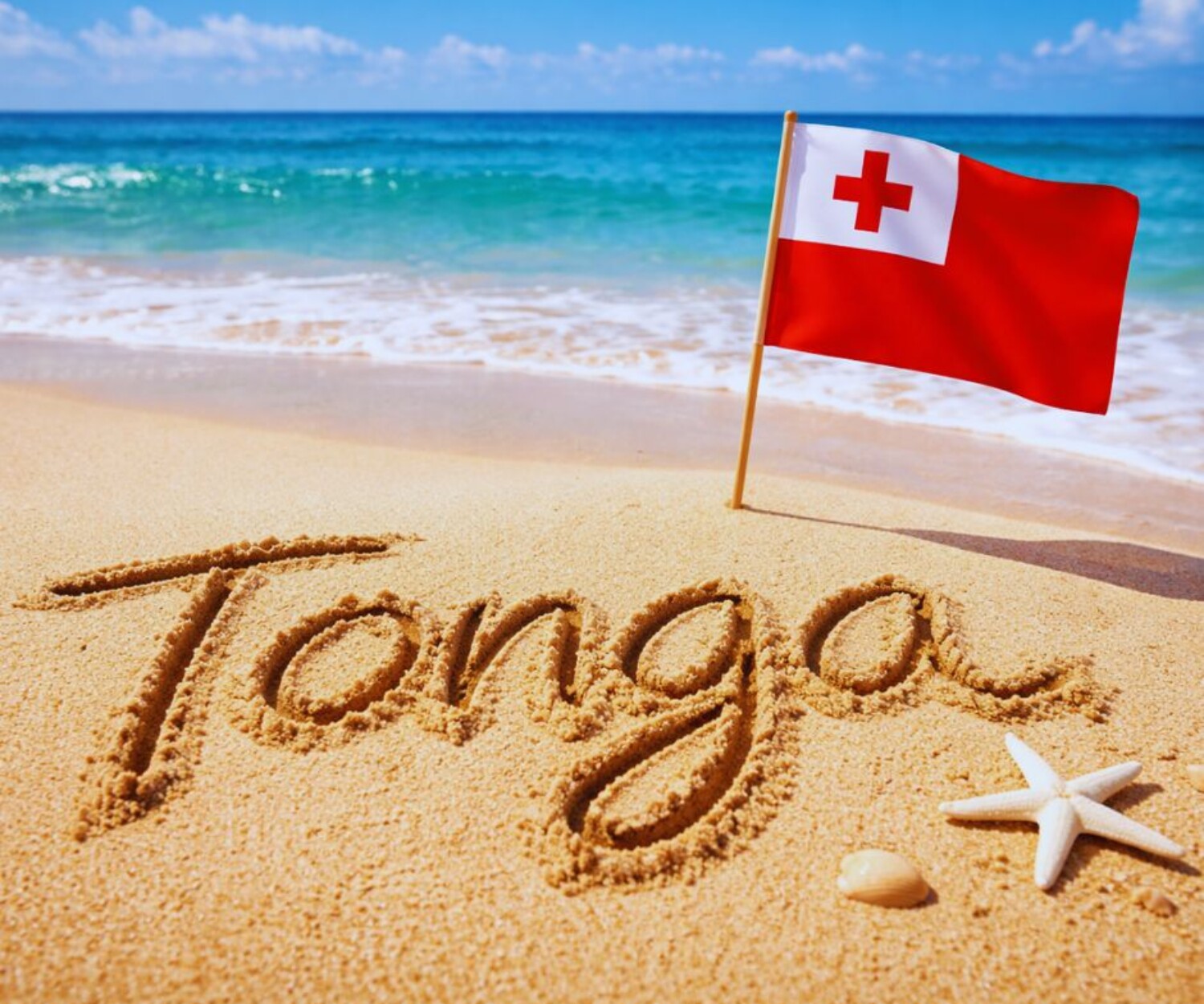 Tonga written in sand with a Tongan flag sticking out of the sand.